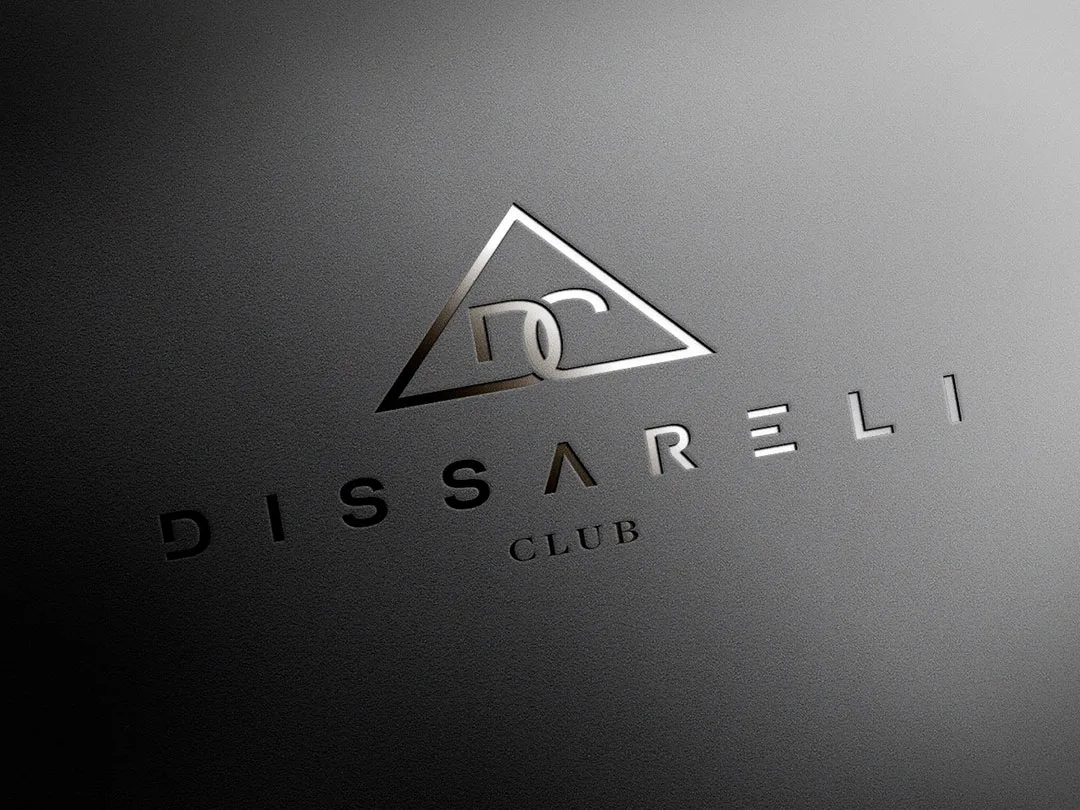 Logotipo Dissareli Club grabado en relieve metálico sobre superficie textil oscura